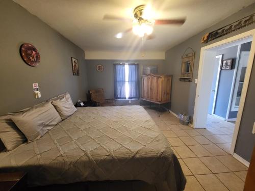 a bedroom with a bed and a ceiling fan at Hill Country Lodge and Mini Storages in Buchanan Dam
