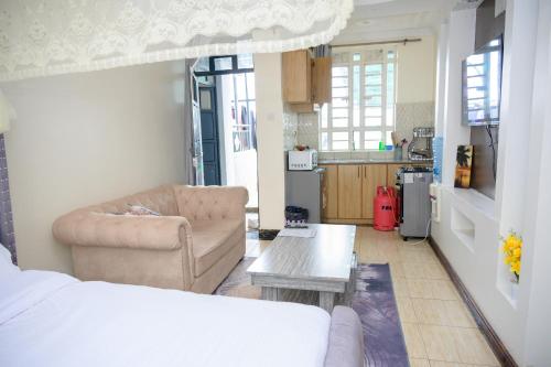 a living room with a couch and a table at SpringStone executive STUDIO apartment A19 in Ongata Rongai 