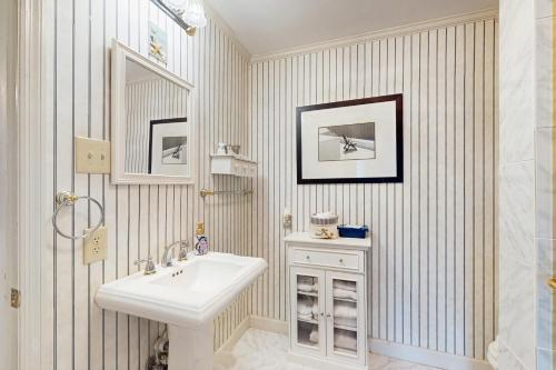 a white bathroom with a sink and a shower at Chowan River Retreat in Edenton