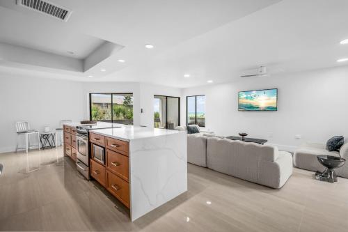a kitchen and living room with a couch and a table at Just Beachy By Beachside Management in Siesta Key