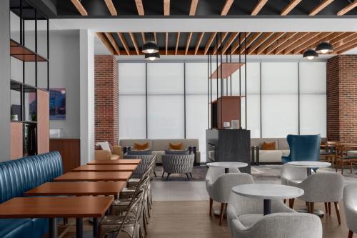 a restaurant with tables and chairs and a lobby at Residence Inn by Marriott Lincoln Downtown in Lincoln