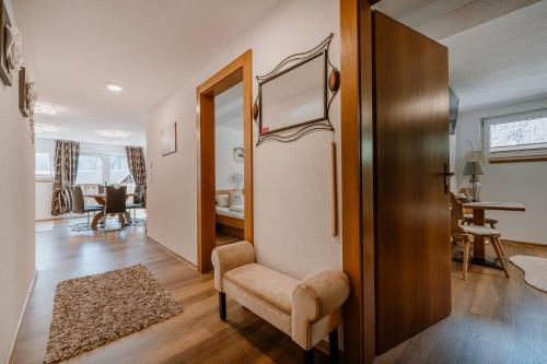 a living room with a chair and a table at Apart Letta in Huben