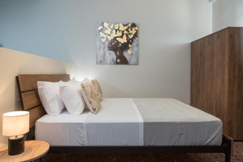 a bedroom with a bed with white sheets and pillows at Fyllianos Apartments in Plátanos