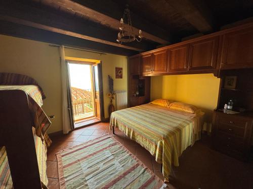 a bedroom with two beds and a window at Bed and Breakfast Vùa in Bova