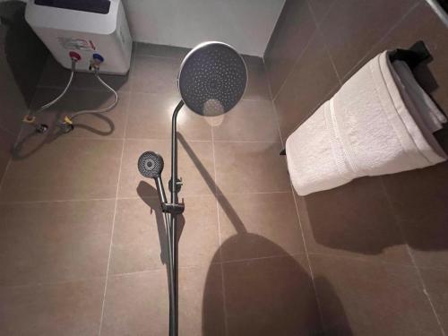 a shower in a bathroom with a shower head at Home2Suite by Veronica Bunga-Buziga-Munyonyo- Luxury with Netflix, DStv, Wi-Fi, & Free Parking in Kampala