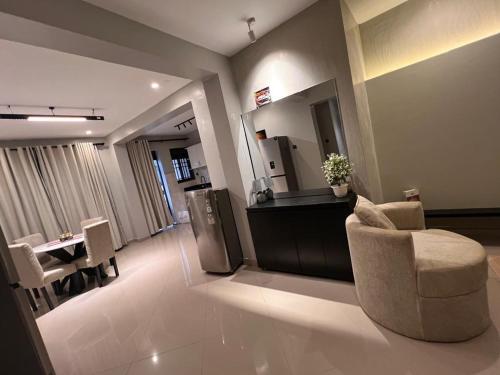 a lobby with a chair and a table and a mirror at Home2Suite by Veronica Bunga-Buziga-Munyonyo- Luxury with Netflix, DStv, Wi-Fi, & Free Parking in Kampala