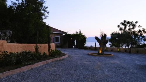 a house with a statue in the middle of a driveway at Trabala Ionian Living in Paleros