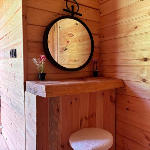 a bathroom with a mirror and a stool in a cabin at Yaylamisun Suite Otel in Çamlıhemşin
