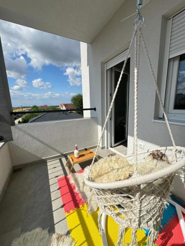 a swing on the balcony of a house at Belgrade Airport luxury 2 room in Surčin