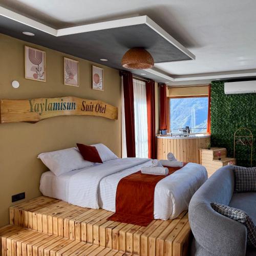 a bedroom with a bed on a wooden platform at Yaylamisun Suite Otel in Çamlıhemşin