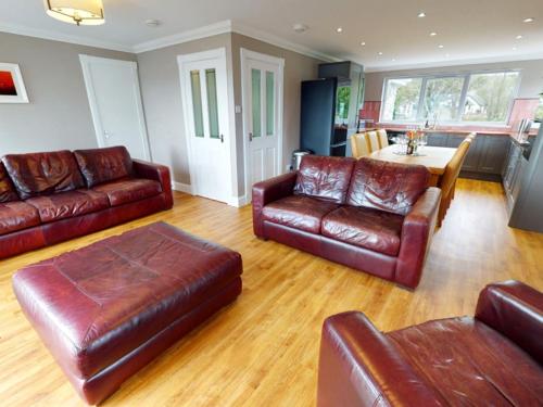 a living room with leather furniture and a table at 3 bed property in Onich CA159 in Onich