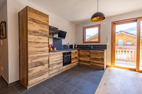 a kitchen with a large wooden wall at 5-Person Apartment with Large Terrace in Les Allues