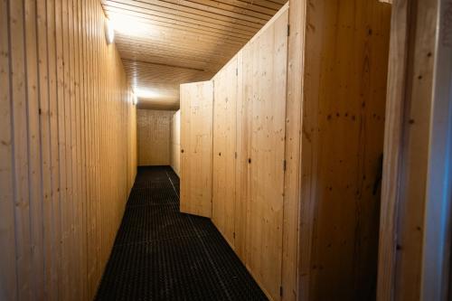 a hallway with wood paneled walls and a long corridor at 5-Person Apartment with Large Terrace in Les Allues