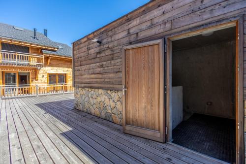 a wooden building with a door on a deck at 5-Person Apartment with Large Terrace in Les Allues