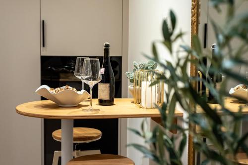 a table with wine bottles and glasses on it at Rooms & Apartment Laura in Split