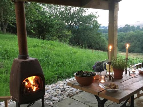 a wood fired oven sitting on a table next to a field at 1 Bed in Goathland G0140 in Goathland