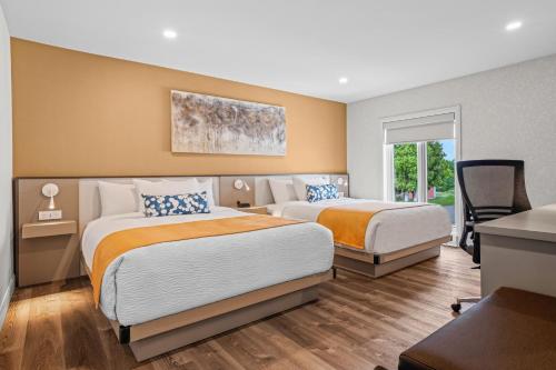 Ένα ή περισσότερα κρεβάτια σε δωμάτιο στο Days Inn by Wyndham Riviere-Du-Loup