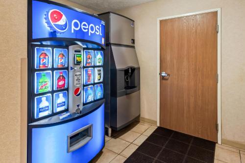 a pepsi machine in a room next to a door at Comfort Suites Clackamas in Clackamas