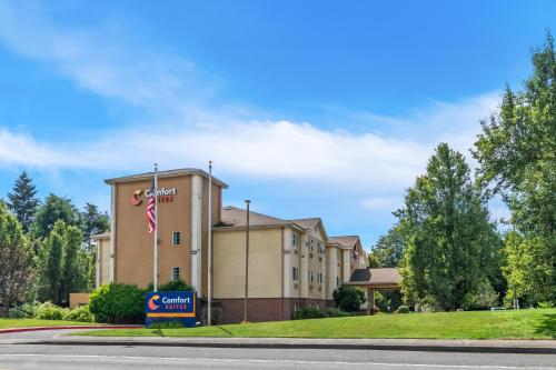a hotel building with a sign in front of it at Comfort Suites Clackamas in Clackamas