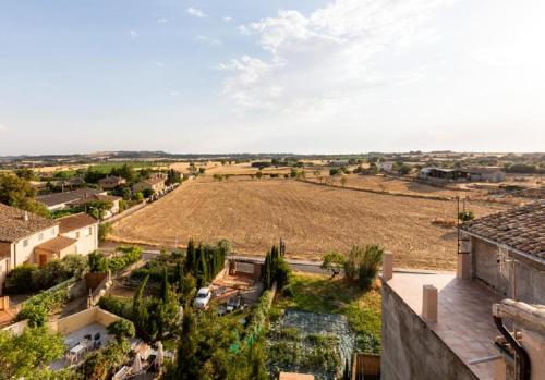 a view of a field from a house at Apartamentos Vino Tinto y Restaurante Tomate Rosa in Adahuesca