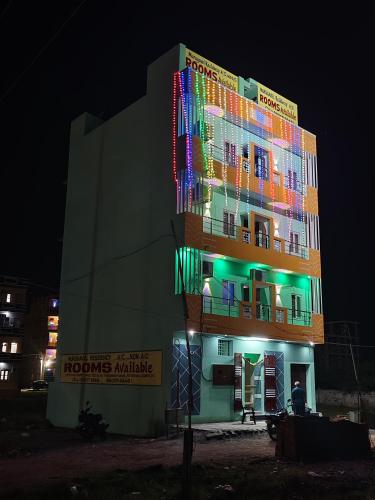 a building with colorful lights on it at night at Murugavel Residency in Vishāram