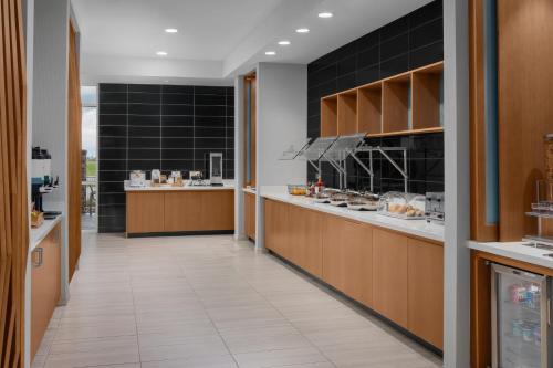 a kitchen with black tiles on the walls at SpringHill Suites by Marriott Grand Island in Grand Island