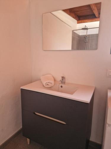 a bathroom with a sink and a mirror at La Chosita in Icod de los Vinos