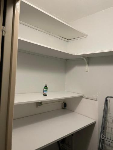 a empty closet with a shelf with a bottle on it at Cocon du Jaï in Marignane