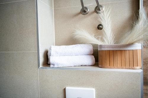 a bathroom with a shelf with towels on it at Most - Bitka za ranjenike na Neretvi in Jablanica