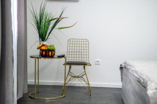 a chair and a table with a plant on it at Most - Bitka za ranjenike na Neretvi in Jablanica