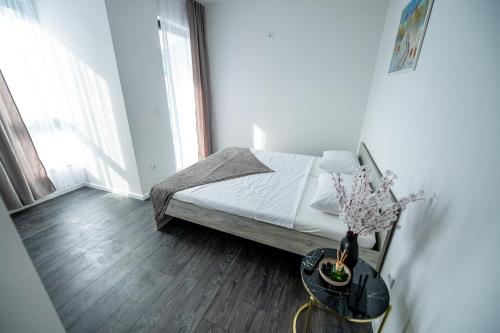 a bedroom with a bed and a table with a vase at Most - Bitka za ranjenike na Neretvi in Jablanica