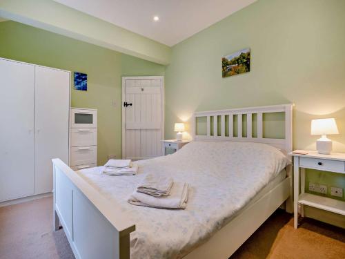 a bedroom with a bed with two towels on it at 3 Bed in Bamford PK838 in Bamford