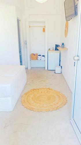 a room with a large rug on the floor at Thea in Livadakia