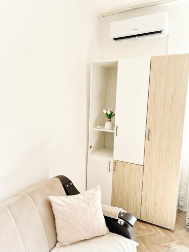 a living room with a couch and a door at Home NP Apartments in Novi Pazar