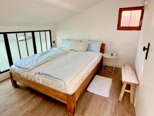 a bedroom with a large bed in a room at Contemporary-style pavilion in Narbonne