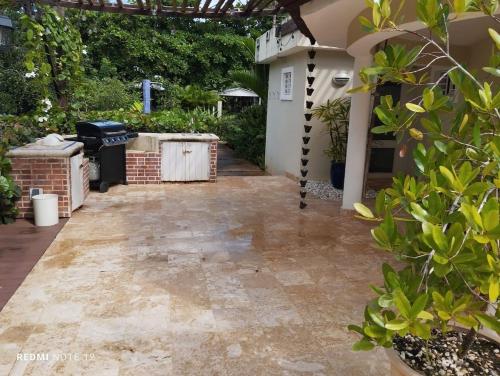 a backyard with a stone walkway leading to a house at Family Villa in Las Galeras, Samaná in Las Galeras