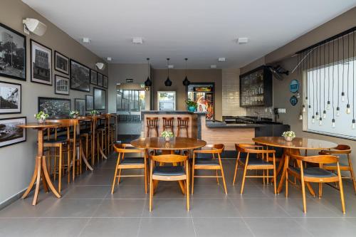 a dining room with wooden tables and chairs at Araçatuba Plaza Hotel in Araçatuba