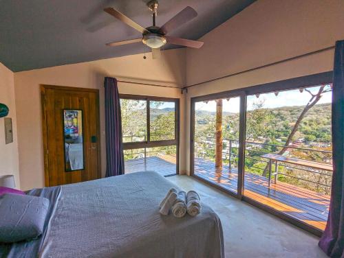 a bedroom with a bed and a large window at Colina Escondida: monoAmbiente in San Juan del Sur