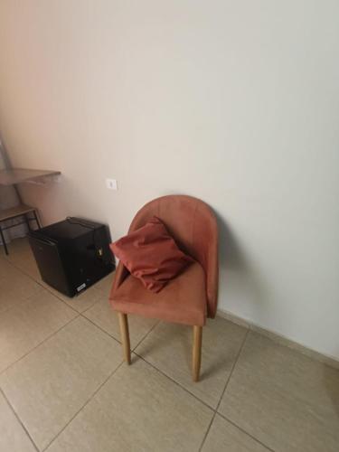 a chair with a blanket on top of it at Sallimas Hotel in Sorocaba