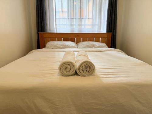 two towels on a bed in front of a window at Cozy Escape in Ongata Rongai 