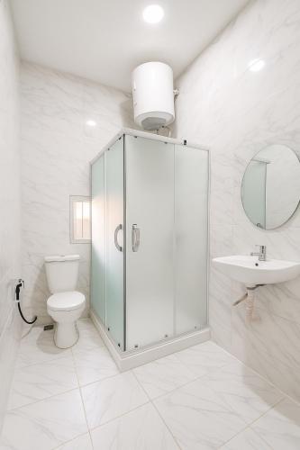 a bathroom with a shower and a toilet and a sink at Essential Comfort Haven Homez in Ago Palace in Lagos