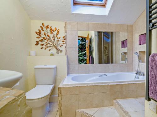 a bathroom with a tub and a toilet and a sink at 2 Bed in Coleford 78181 in Symonds Yat