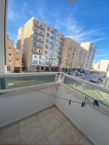 a balcony with a view of a city at Apartment haut standing in Hammam Sousse