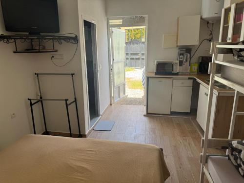 a room with a kitchen with a bed in it at Dar Lhmam in Asilah