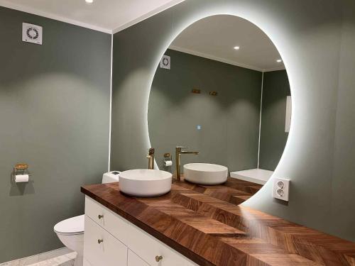 a bathroom with two sinks and a mirror at Fonnagata in Åndalsnes