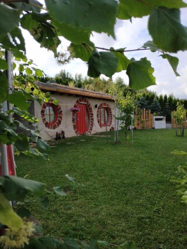 a house with red shuttered windows in a yard at Wilkowka in Wołkowyja