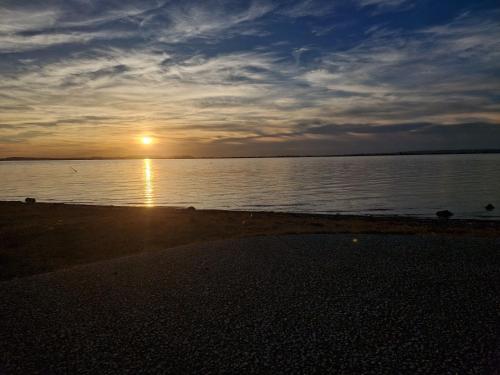 a sunset on the beach with the sun setting at Cocon du Jaï in Marignane