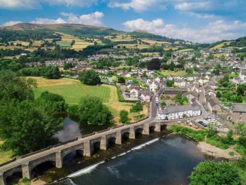 an aerial view of a town with a bridge over a river at 2 bed in Llangynidr BN023 in Llangynidr