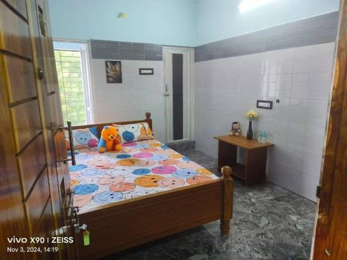 a bedroom with a bed with a teddy bear on it at Raja Residency & Room stay in Papanāsam