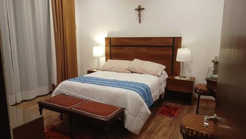 a bedroom with a bed and a cross on the wall at New house with pool, excellent, 3 bedrooms in Pazulco